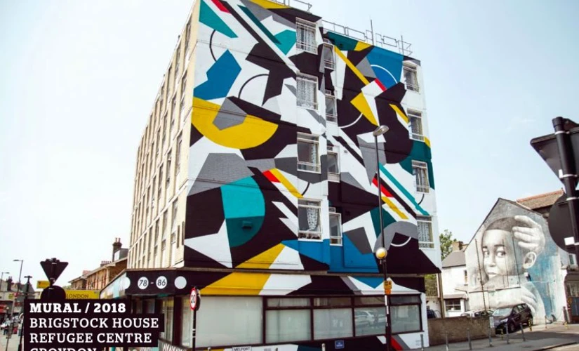Large building with abstract art over the side