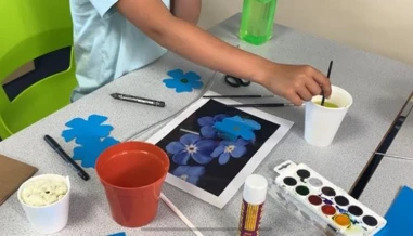 child painting a flower