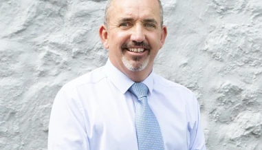 man smiling on grey background