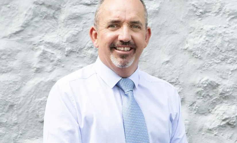 man smiling on grey background