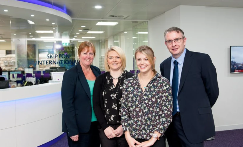 Four people in Skipton International's Lobby