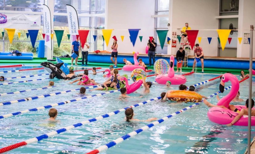 group of young children playing in swimming pool