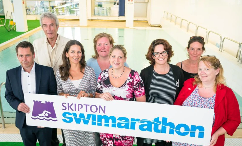 People holding Swimarathon sign