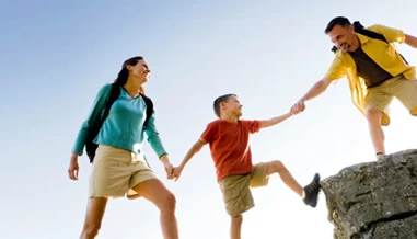 Family climbing onto rocks