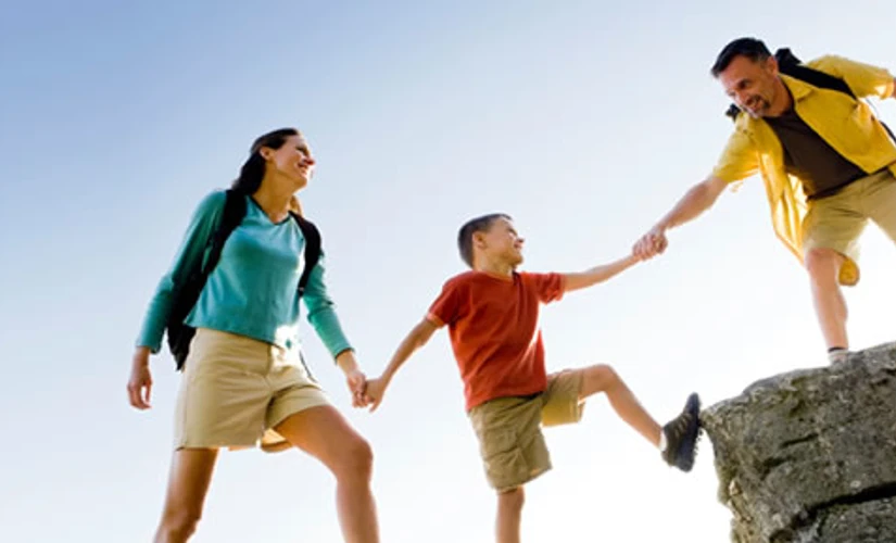 Family climbing onto rocks