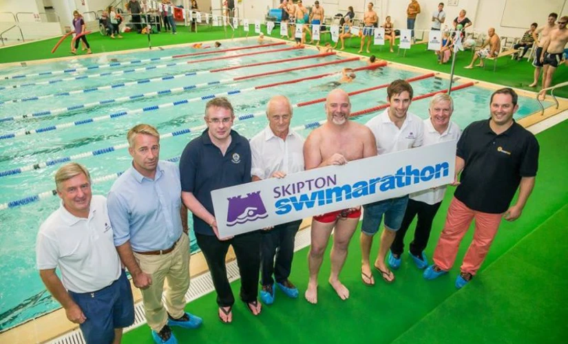 People holding Swimarathon sign