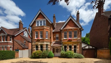 Large home with blue skies and clouds