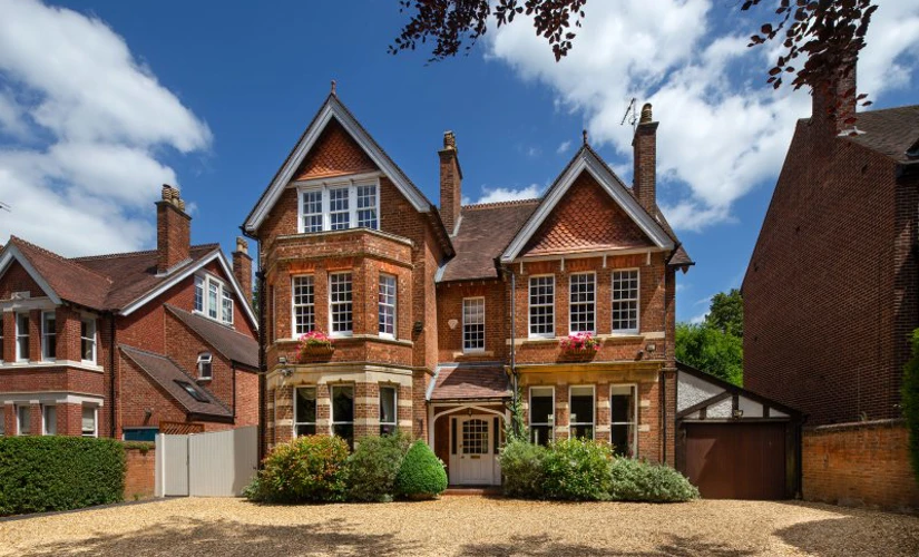 Large home with blue skies and clouds