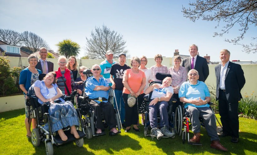 group of people pose in a sunny garden