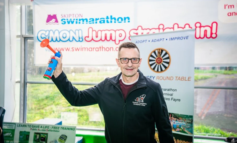 Skipton beneficiary holding air horn at Skipton Swimarathon