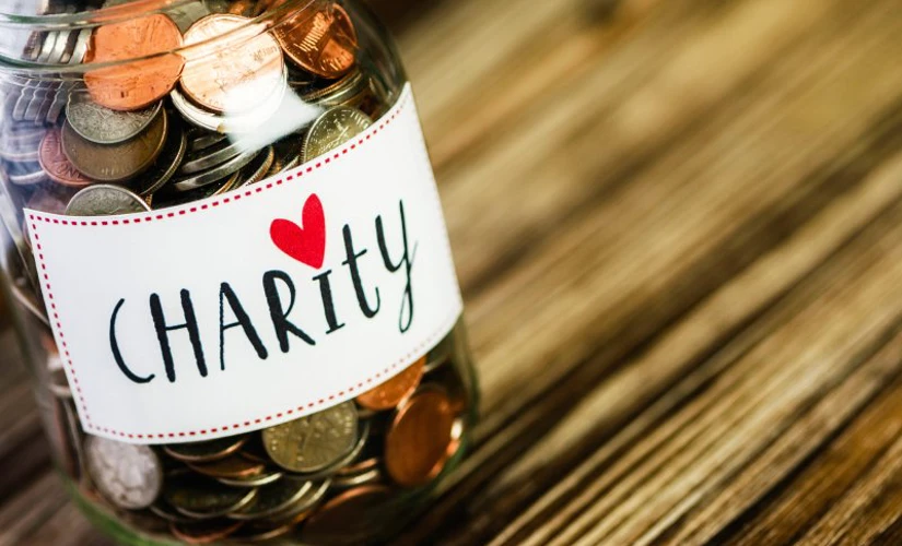 pennies in a jar with "charity" on the front