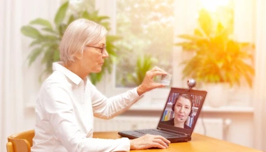 woman talking to a person throw video call
