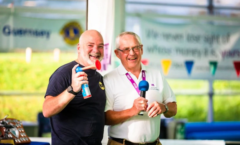 two men holding an airhorn and a microphone