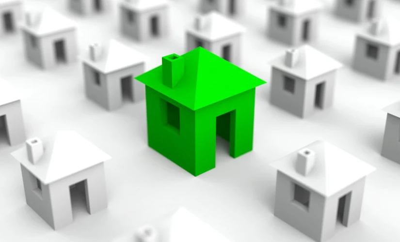 small animated houses with green house in focus
