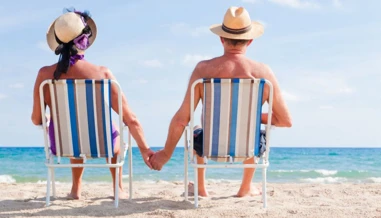 retired couple relaxing on the beach 