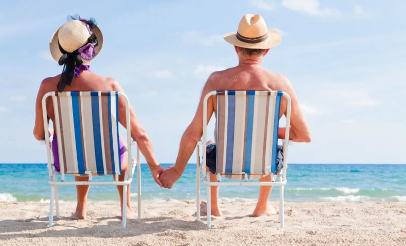 retired couple relaxing on the beach