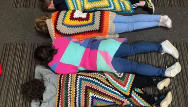 children wrapped in quilted blankets