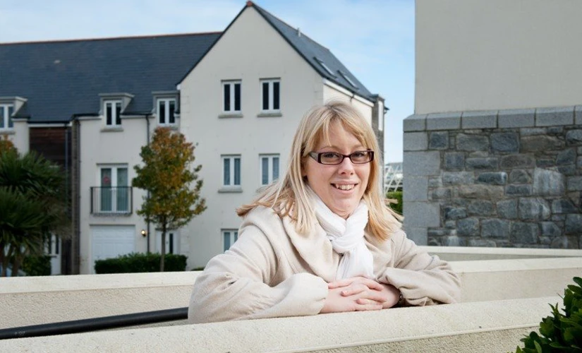 Happy lady in front of houses