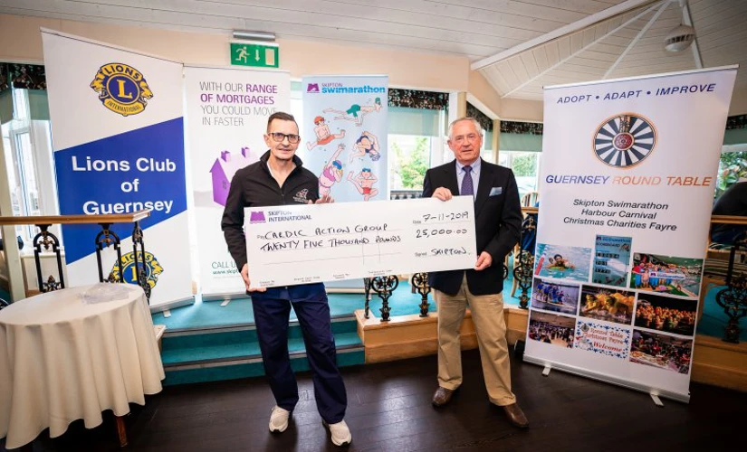 Skipton Swimarathon Beneficiaries holding large cheque