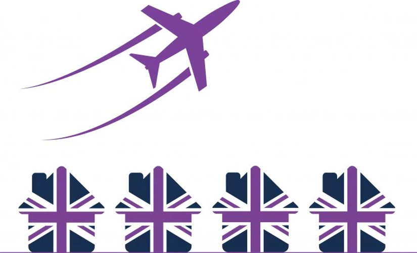 Union jack houses underneath purple aeroplane 