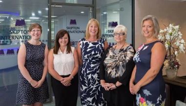 Five women photographed in Skipton International Limited's lobby