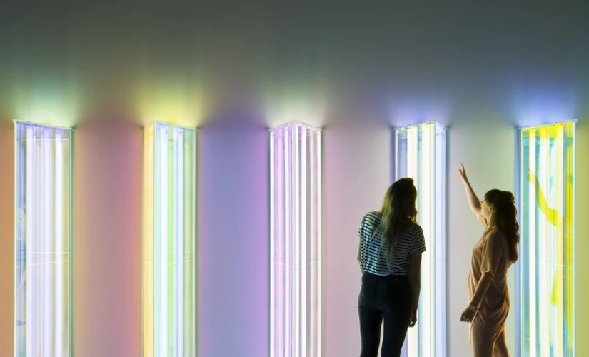 two people looking at coloured lighting