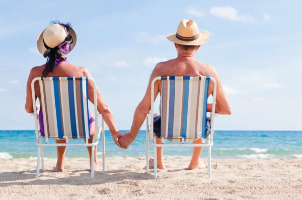 Retired couple sitting on the beach