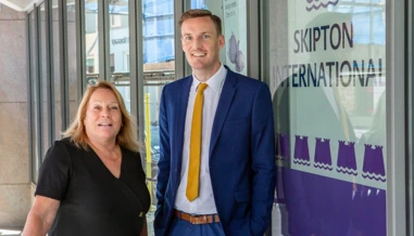 people smiling outside of Skipton office