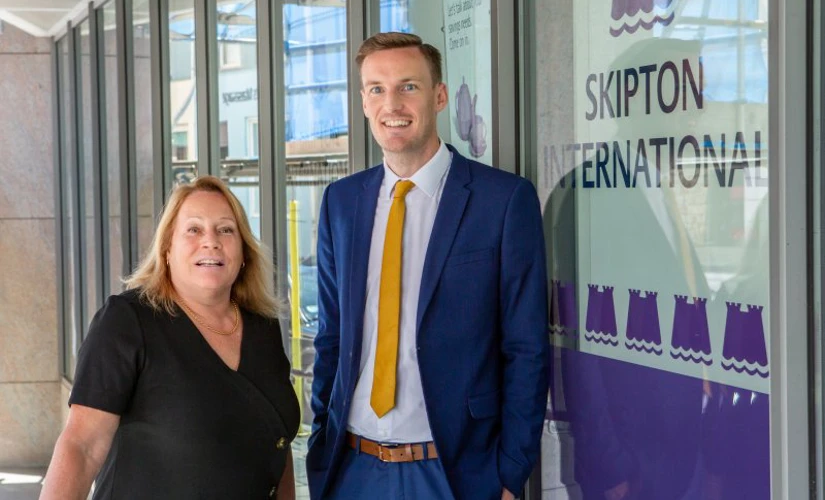 people smiling outside of Skipton office