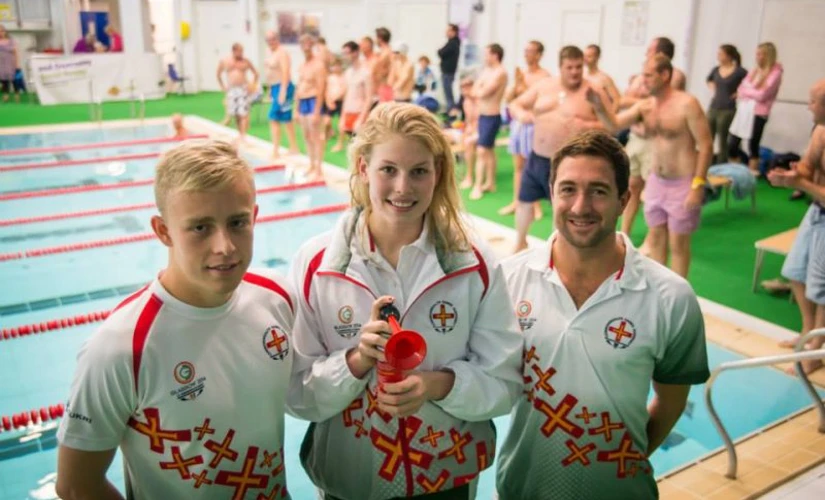 3 people in front of a pool