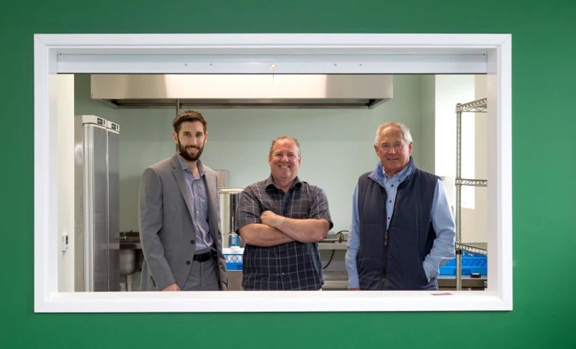 three men in canteen window